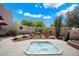 Backyard with a hot tub, fountain, desert landscape, and a privacy wall at 8879 E Greenview Dr, Gold Canyon, AZ 85118