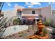 Spacious backyard featuring a hot tub, fountain, mature trees, and patio area at 8879 E Greenview Dr, Gold Canyon, AZ 85118