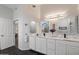 Bright bathroom featuring double sinks, marble counters, and decorative mirrors at 8879 E Greenview Dr, Gold Canyon, AZ 85118