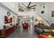Open living room with staircase, stylish decor, and a view into the kitchen area at 8879 E Greenview Dr, Gold Canyon, AZ 85118