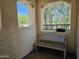 Secluded balcony with a bench, stucco walls, and view of a tree canopy at 9137 W Coolbrook Ave, Peoria, AZ 85382