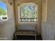 A cozy balcony featuring a bench and a charming view through a unique framed opening at 9137 W Coolbrook Ave, Peoria, AZ 85382