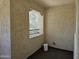 Enclosed balcony with stucco walls, window framing, and a view of exterior foliage at 9137 W Coolbrook Ave, Peoria, AZ 85382