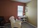 Well-lit Bedroom with a white rocking chair, shelving, and a changing table at 9137 W Coolbrook Ave, Peoria, AZ 85382