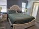 A bedroom with a stylish bed, bedside tables, and large windows for natural light at 9137 W Coolbrook Ave, Peoria, AZ 85382