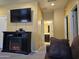 A bonus room featuring a fireplace, large TV, and view into an adjacent bathroom at 9137 W Coolbrook Ave, Peoria, AZ 85382