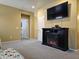 Spacious bonus room featuring a fireplace, large TV, and neutral carpeting at 9137 W Coolbrook Ave, Peoria, AZ 85382