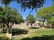 Well-kept community green space with mature trees, landscaping, and walking path at 9137 W Coolbrook Ave, Peoria, AZ 85382