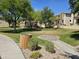 An expanse of manicured community green space with walking paths and lush landscaping at 9137 W Coolbrook Ave, Peoria, AZ 85382