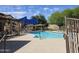 Relaxing community pool area with sunshades, lounge chairs, and well-maintained landscaping at 9137 W Coolbrook Ave, Peoria, AZ 85382