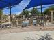A refreshing community pool area with comfortable lounge seating and shaded umbrellas at 9137 W Coolbrook Ave, Peoria, AZ 85382