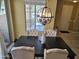 Inviting dining area with a chandelier, a view to front yard, and comfortable seating for Gathering meals at 9137 W Coolbrook Ave, Peoria, AZ 85382