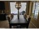 Open dining space features a modern light fixture, access to the patio, and neutral-toned furniture at 9137 W Coolbrook Ave, Peoria, AZ 85382