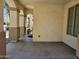 Spacious covered front porch with an inviting view, showcasing classic columns, textured walls, and natural light at 9137 W Coolbrook Ave, Peoria, AZ 85382