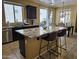 Well-equipped kitchen features stainless appliances, dark cabinetry and granite countertops at 9137 W Coolbrook Ave, Peoria, AZ 85382