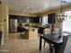 Spacious kitchen featuring dark cabinetry and an island with granite countertops at 9137 W Coolbrook Ave, Peoria, AZ 85382