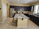 Stylish kitchen featuring dark cabinets, stainless steel appliances and granite countertops at 9137 W Coolbrook Ave, Peoria, AZ 85382