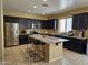 Lovely kitchen boasts a large island with granite countertops at 9137 W Coolbrook Ave, Peoria, AZ 85382
