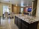 Open-concept kitchen and dining area with a stylish chandelier and view of Gathering room at 9137 W Coolbrook Ave, Peoria, AZ 85382