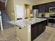 Contemporary kitchen featuring a granite island, stainless steel appliances, and sleek design at 9137 W Coolbrook Ave, Peoria, AZ 85382