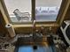 View of the kitchen sink with granite countertops and a view of outdoor patio at 9137 W Coolbrook Ave, Peoria, AZ 85382