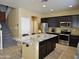 Modern kitchen with stainless steel appliances and a large granite island at 9137 W Coolbrook Ave, Peoria, AZ 85382