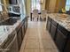 View of the kitchen featuring granite counters, stainless steel sink, and adjoining dining area at 9137 W Coolbrook Ave, Peoria, AZ 85382