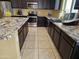 This kitchen features granite countertops, stainless steel appliances, and dark cabinetry at 9137 W Coolbrook Ave, Peoria, AZ 85382