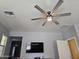 Spacious living room with a ceiling fan and TV at 9137 W Coolbrook Ave, Peoria, AZ 85382