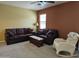 Comfortable living room featuring plush sofas, a rocking chair, and neutral carpeting at 9137 W Coolbrook Ave, Peoria, AZ 85382