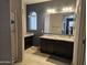 Bathroom featuring a dark vanity, ample counter space, and modern fixtures at 9137 W Coolbrook Ave, Peoria, AZ 85382
