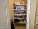 Organized walk-in pantry featuring built-in shelving, providing ample storage for food and household items at 9137 W Coolbrook Ave, Peoria, AZ 85382