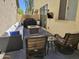 Comfortable outdoor patio with cushioned seating, fire pit, grill, and mounted television for relaxed entertaining at 9137 W Coolbrook Ave, Peoria, AZ 85382