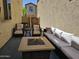 Relaxing outdoor patio with fire pit, seating and dining area for casual gatherings and outdoor enjoyment at 9137 W Coolbrook Ave, Peoria, AZ 85382