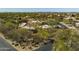 Stunning aerial view of a desert community with mature trees and landscaping at 9154 E Sunflower Ct, Scottsdale, AZ 85266