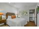 Bright bedroom with a queen bed, side tables and lamps. Includes a window view, walk-in closet, and carpeted floors at 9154 E Sunflower Ct, Scottsdale, AZ 85266