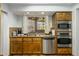 Well lit kitchen featuring stainless steel appliances, wooden cabinets, and a view to the outside at 9154 E Sunflower Ct, Scottsdale, AZ 85266