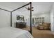 Well-lit primary bedroom with a four-poster bed, dresser with tv, chair and ottoman, and access to the outside at 9154 E Sunflower Ct, Scottsdale, AZ 85266