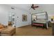 Spacious primary bedroom featuring a sitting area, ensuite bathroom, and a four-poster bed at 9154 E Sunflower Ct, Scottsdale, AZ 85266