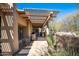 Inviting outdoor patio featuring a charming pergola, seating area, and lush desert landscaping at 9154 E Sunflower Ct, Scottsdale, AZ 85266