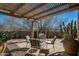 Charming outdoor patio with desert landscaping, view fencing, and shaded seating area at 9154 E Sunflower Ct, Scottsdale, AZ 85266