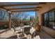 Charming outdoor patio with desert landscaping, view fencing, and shaded seating area at 9154 E Sunflower Ct, Scottsdale, AZ 85266