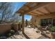 Charming outdoor patio with desert landscaping, view fencing, and shaded seating area at 9154 E Sunflower Ct, Scottsdale, AZ 85266