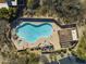 Aerial view of a community pool with multiple lounge chairs, a spa, and a covered patio area at 9154 E Sunflower Ct, Scottsdale, AZ 85266