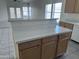 Bright kitchen featuring a quartz kitchen island with a breakfast bar, open to the living area at 11827 W Roanoke Ave, Avondale, AZ 85392