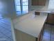 Bright kitchen featuring a quartz kitchen island with a breakfast bar, and lots of outlets at 11827 W Roanoke Ave, Avondale, AZ 85392