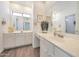 Bright bathroom features a well-lit vanity, dual mirrors, and tiled floors at 11832 E Clinton St, Scottsdale, AZ 85259