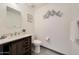 Charming bathroom features rustic vanity with modern fixtures and a decorative mirror at 11832 E Clinton St, Scottsdale, AZ 85259