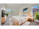 Bright bedroom with large windows, natural wood furniture, neutral decor and lots of light at 11832 E Clinton St, Scottsdale, AZ 85259
