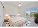 Well-lit bedroom features neutral decor, modern furniture, and natural light from the large window at 11832 E Clinton St, Scottsdale, AZ 85259